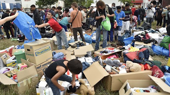 Boxes of donated clothes and children's toys at a refugee shelter in Heidenau, Germany.