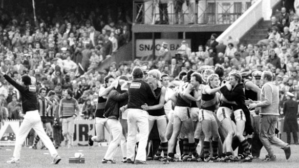 Jubilant Essendon players and officials celebrate their 1984 grand final win.