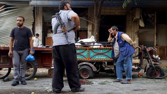 A man reacts at a site damaged by what activists said was an air strike by forces loyal to Syria's President Bashar al-Assad on a vegetable market in Idlib on Tuesday.