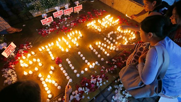Human rights activists light candles in Quezon City for the victims of extra-judicial killings.