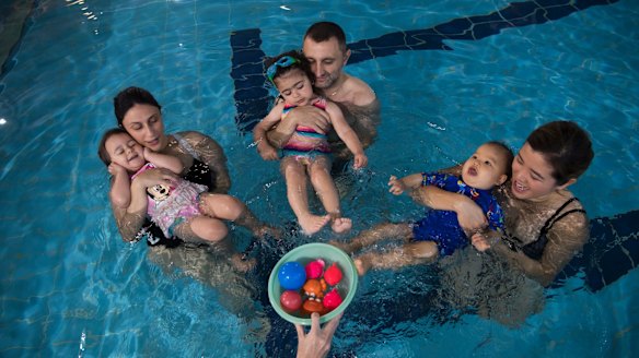 Emilia Garofolo, 2, and mum Amanda; Elsie Kassis with dad Nagib, and Mason, nine months, with mum Jannine Lam were among those at swimming lessons.