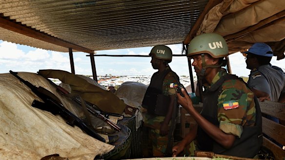 Two UN soldiers from Ethiopia in a guard tower radio their base over a possible security threat near the UN Protection of Civilians site in Juba in April.