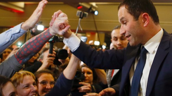 Benoit Hamon greets supporters after winning the socialist party presidential nomination in Paris, on Sunday.