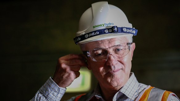 Prime Minister Malcolm Turnbull puts in ear plugs during a visit to the Snowy Hydro plant.