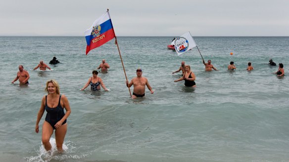 Crimean people wave a Russian national flag celebrating Orthodox Christmas in the Black Sea in Yevpatoriya earlier this year.