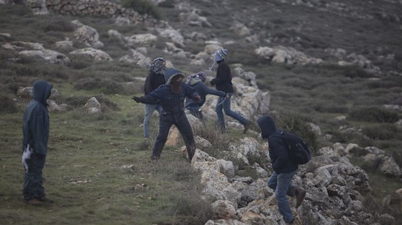 Settlers throw stones  at Israeli police in Amona, West Bank.