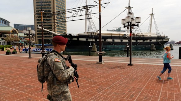 A National Guard trooper patrols Baltimore's harbour area.