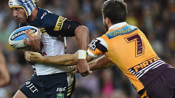 Halted: Johnathan Thurston is caught by Ben Hunt.