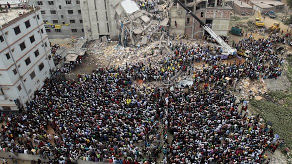 Bangladeshis gather to watch the rescue effort at the collapsed Rana Plaza building in Savar, near the capital Dhaka, in April 2013. 