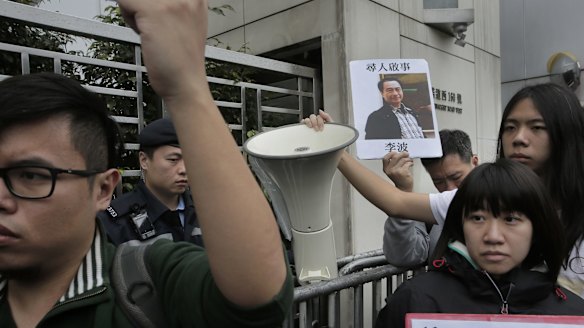A protester with  a photo of missing bookseller Lee Bo in Hong Kong on Sunday.