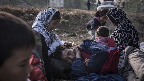 Getting warm with a small fire after crossing the Serbian border into Hungary near the town of Asotthalom on Sunday. 