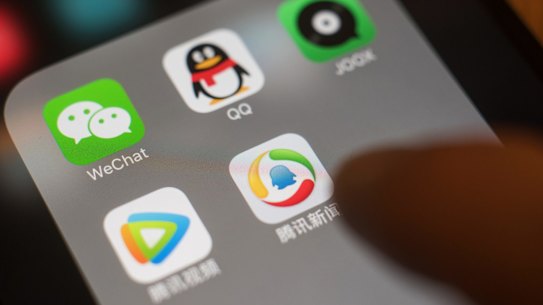 The icons for Tencent Holdings Ltd. applications WeChat, clockwise from top left, QQ, JOOX, Tencent News and Tencent Video are arranged for a photograph on an Apple Inc. iPhone in an arranged photograph taken in Hong Kong, China, on Wednesday, July 26, 2017. Tencent is scheduled to release second-quarter earnings figures on Aug 16. Photographer: Anthony Kwan/Bloomberg