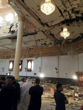 Police inspect the mosque after the explosion.