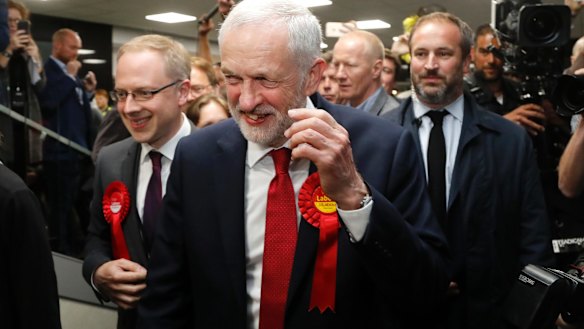 Labour Party leader Jeremy Corbyn smiles after arriving at his constituency in London.