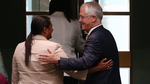 Mr Turnbull embraces Labor Senator Nova Peris after he delivered the report.