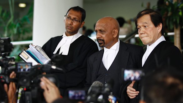 Hisyam Teh Poh Teik, right, and Naran Singh, centre, lawyers for Doan Thi Huong, speak to journalists after the court hearing.