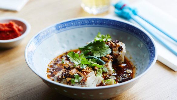 Steamed barramundi wrapped in salted cabbage and served with soy dressing.