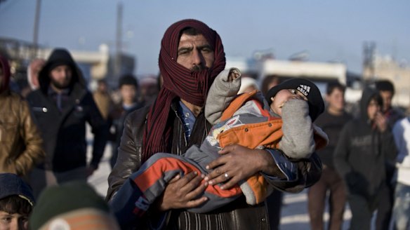 Syrians, many from Aleppo, walk towards the Turkish border at the Bab al-Salam border gate last week. 