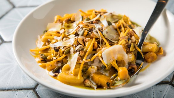 Pumpkin macaroni with pumpkin seeds, shreds of pumpkin and pumpkin chips.