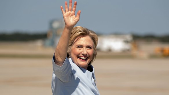 Hillary Clinton waves as she arrives at Cleveland Hopkins International Airport. Some conspiracy theorists have even claimed the candidate's facial expressions are a sign of illness.