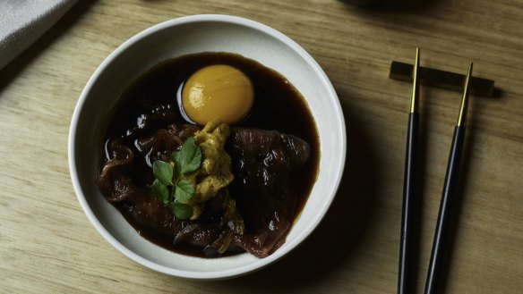 Kagoshima wagyu sukiyaki with sea urchin, raw egg yolk and sweet onions.