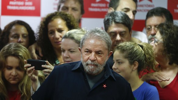 Brazil's former president Luiz Inacio Lula da Silva, centre, after being questioned in a snowballing corruption probe this month.