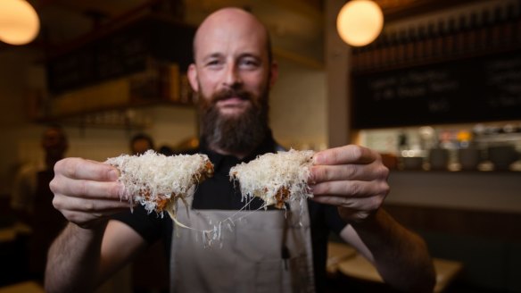 The Hardware Club chef Nicola Dusi with his cacio e pepe jaffle, inspired by an Italian dish called mozzarella en carozza and the Aussie toasted sandwich.