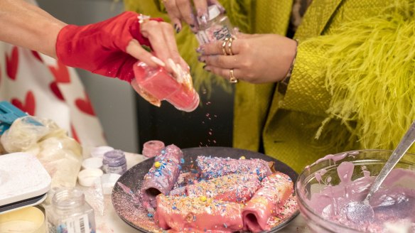 Paris Hilton and Demi Lovato decorating a unicorn cannoli (unicorn-olis).