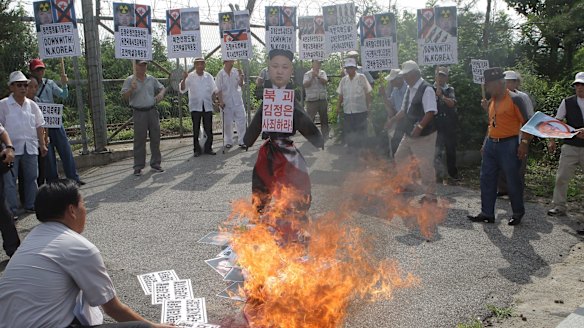 South Korean conservative protesters burn a effigy of North Korean leader Kim Jong-Un and flag during a anti-North Korea rally near the demilitarised zone at Imjingak on Tuesday.
