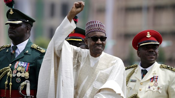 Nigerian President Muhammadu Buhari salutes his supporters during his Inauguration in Abuja, Nigeria, in May.