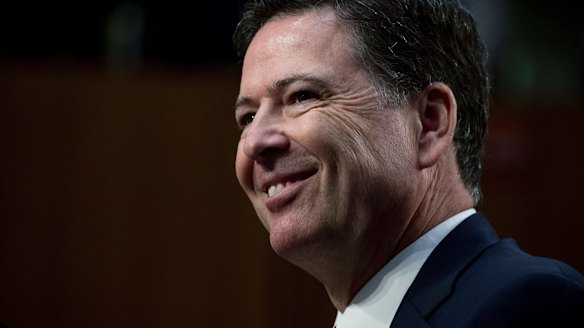 Former FBI Director James Comey smiles during a Senate Intelligence Committee hearing last week.