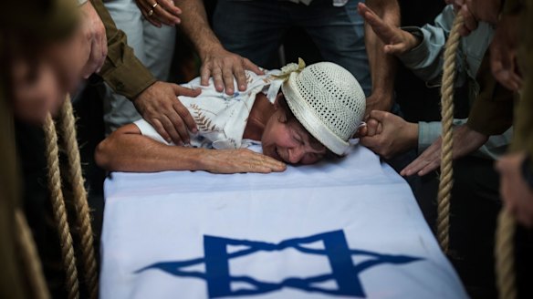 The grandmother of Israeli soldier Jordan Bensimon cries over his coffin in Ashkelon, Israel, during Operation Protective Edge.