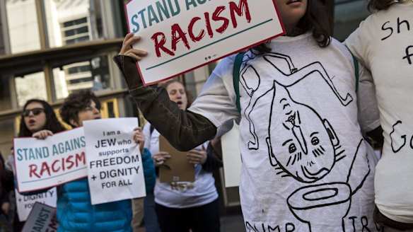 Protesters hold signs and wear homemade shirts in Washington on Monday. More Americans think unfavourably of Trump now than at the start of this year.