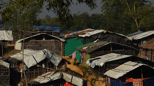 A woman holds a bucket of clothes at the Kutupalong camp, home to hundreds of thousands of Rohingya refugees in Cox's Bazaar, Bangladesh.