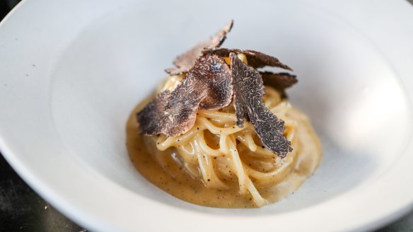 Handmade cacio e pepe spaghetti with black truffles. 