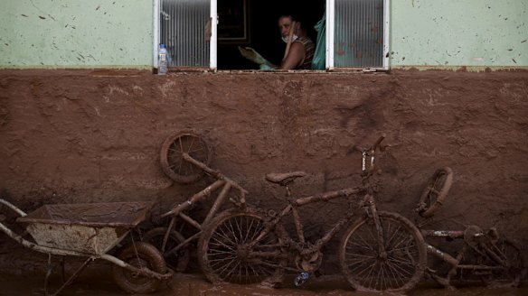 A man works on the cleaning of a house flooded with mud in Barra Longa, Minas Gerais, two days after the accident.
