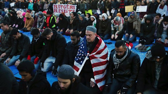 Rutgers University students and supporters gather for Muslim Prayers during a rally to express discontent with President Donald Trump's executive order.