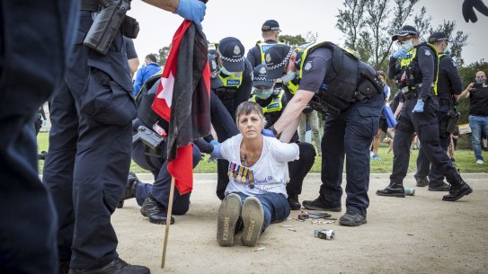 Protesters clash with police at a 'Freedom Day' rally outside the Shrine of Remembrance.