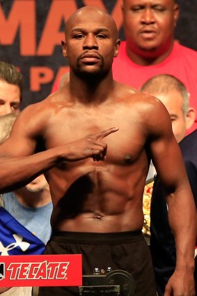 Floyd Mayweather Jr. poses on the scale.