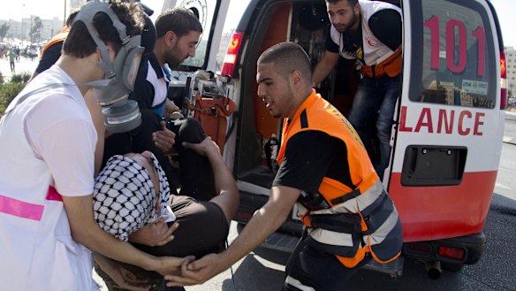 Palestinians help an injured demonstrator during clashes with Israeli troops near Ramallah, West Bank, on Friday.
