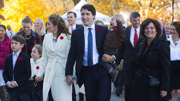 Justin Trudeau, and his wife, Sophie Gregoire-Trudeau, and their children Xavier, Ella-Grace and Hadrien and  Mr Trudeau's mother, Margaret Trudeau, walk to Rideau Hall with his future cabinet to take part in a swearing-in ceremony in Ottawa on Wednesday.