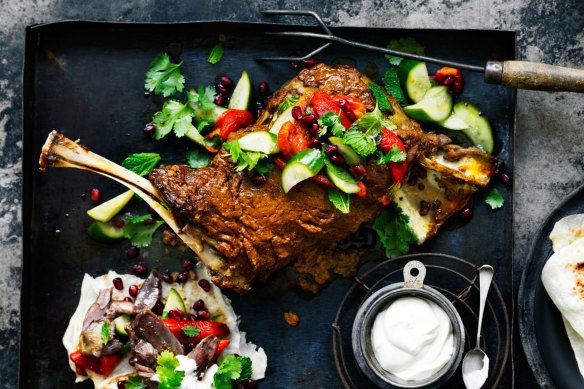 Neil Perry's slow-cooked lamb shoulder with tahini yoghurt, pickled cucumbers, pomegranate and herbs.
