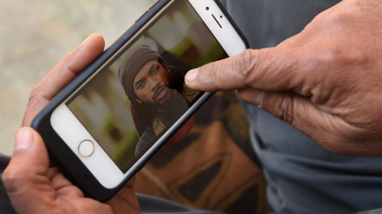 Yusuf Abbas, 51, points to a photo of Neil Prakash identifying him as the foreign fighter he saw in Mosul.
