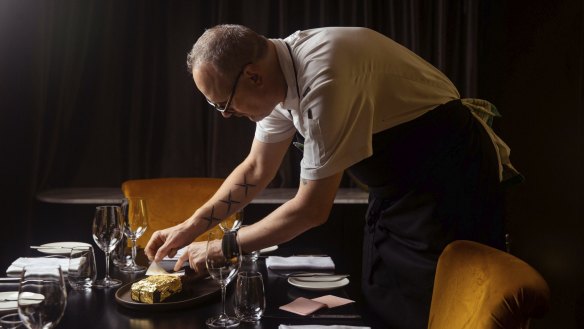 Botswana Butchery head chef Darren Templeton applies gold leaf to a steak.