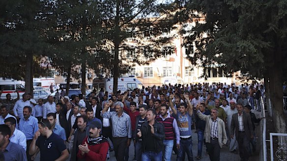 Kurdish men follow a vehicle carrying the body of a  YPG fighter killed in fighting against IS militants.