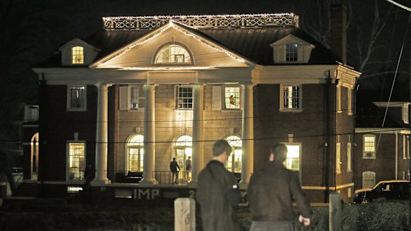 Students outside the Phi Kappa Psi house at the University of Virginia.