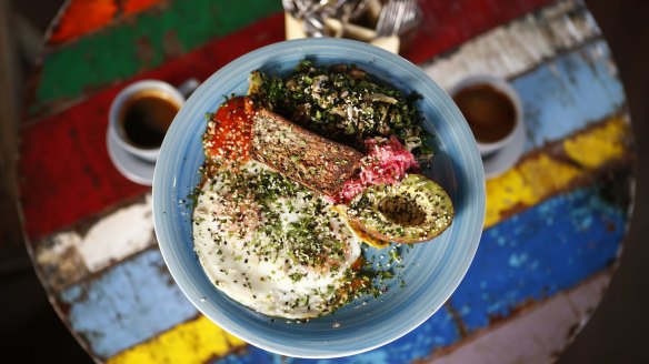 The breakfast plate at Ora includes ghee-fried eggs and gluten-free seed and nut bread.