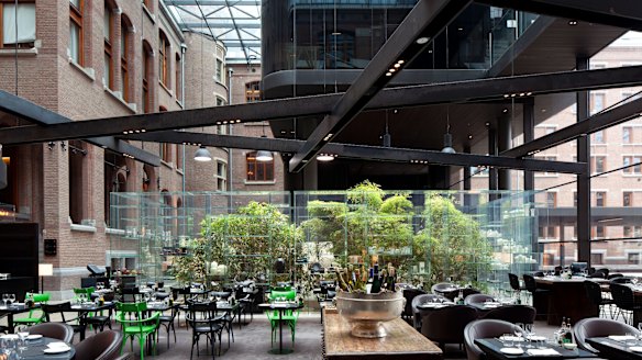 Relax in the brasserie at the Conservatorium hotel under its 42-metre high glass atrium.