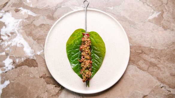 Wagyu tongue skewer wrapped in a betel leaf.