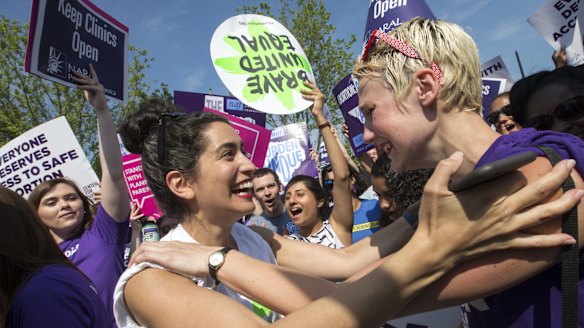 Abortion rights activists Morgan Hopkins of Boston (left) and Alison Turkos of New York City rejoice at the Supreme Court in Washington.